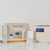 NEOSTRATA Brightening Gift Set contents and cream beauty bag with silver baubles