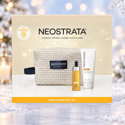 NEOSTRATA Brightening Gift Set box against a snowy Christmas background with warm lights and a snowflake