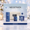 NEOSTRATA Firming Gift Set box against a snowy Christmas background with warm lights and a snowflake