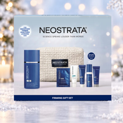 NEOSTRATA Firming Gift Set box against a snowy Christmas background with warm lights and a snowflake