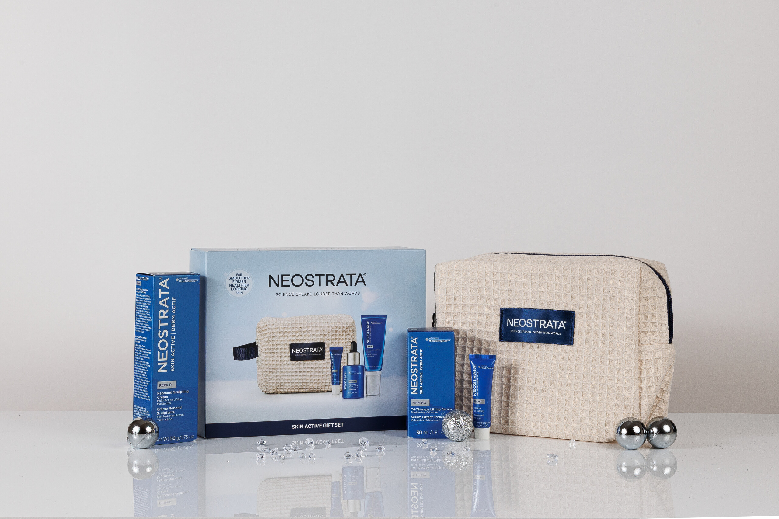 NEOSTRATA Skin Active Gift Set contents and cream beauty bag with silver baubles
