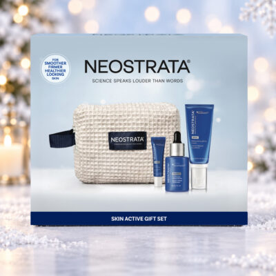 NEOSTRATA Skin Active Gift Set box against a snowy Christmas background with warm lights and a snowflake